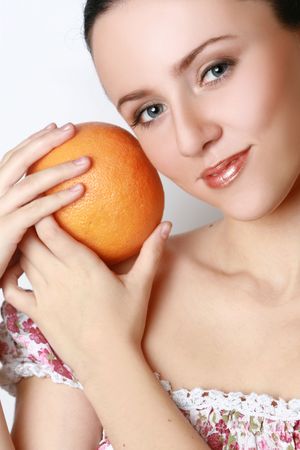 Beautiful woman's face with grapefruitの写真素材