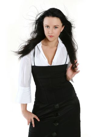Attractive brunette in a black dress and a white shirtの写真素材