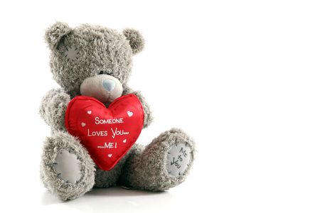 Teddy bear with red heart on white backgroundの写真素材