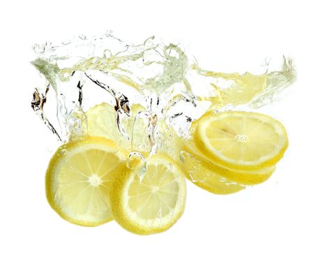 Lemon is dropped into water. isolated on white backgroundの写真素材