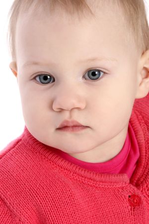 Close-up portrait of a beautiful little baby girl in red jacketの写真素材