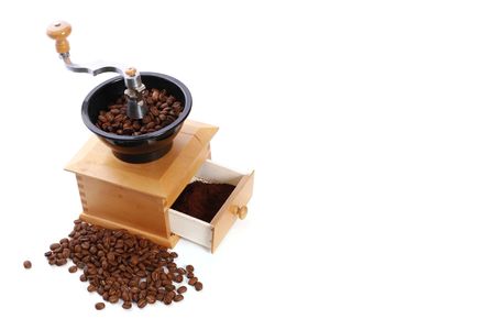 Roasted coffee beans in coffee grinder, isolated on white backgroundの写真素材