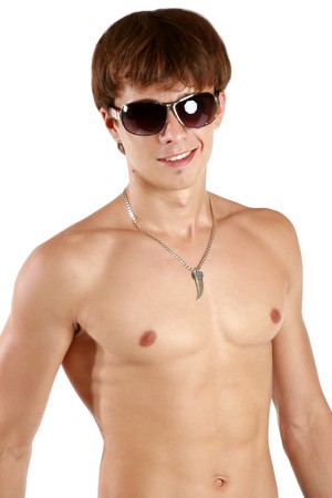 Young fashion man model with athletic body posing in sun glasses on white backgroundの写真素材