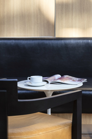 Coffee cup and magazine on table with sofa seat Interior Decorationの写真素材