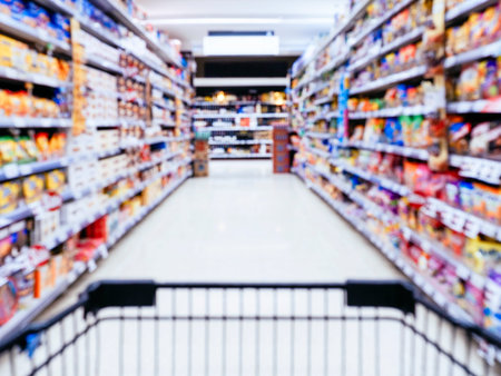 Blurred Supermarket with Shopping cart in perspectiveの写真素材