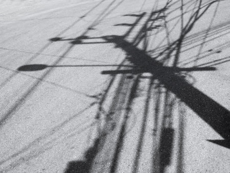 Electric pole mess wiring cable shadow on Street Urban Art Backgroundの写真素材