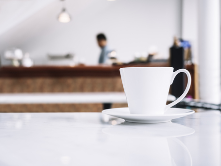 Coffee cup on table with blurred people in Restaurant shop cafeの写真素材