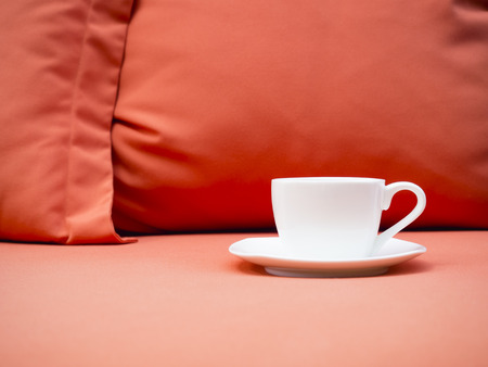 Cup of coffee on Sofa with Pillowの写真素材