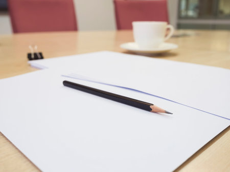 Blank paper document with pencil on Table meeting room