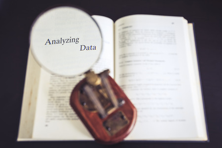 Analyzing data conceptual Magnifying glass on Book Reading Researchの写真素材