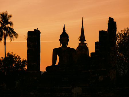 Silhouette Buddha Pagoda landscape sunset at Sukhothai Historical Park World heritage Thailandの写真素材