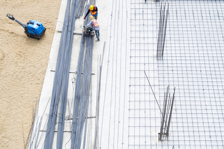 Construction site Workers on cement floor Steel Rods Base Building の写真素材