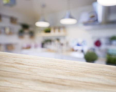 Table top wooden counter Blur Kitchen pantry with shelf and lighting background の写真素材