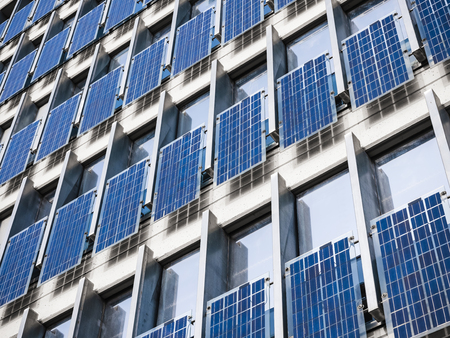 Solar Panel wall on Building Facade clean Energy Industrial utility system Technology backgroundの写真素材