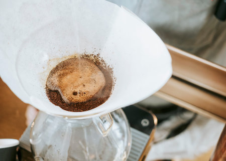 Hand drip coffee, Barista pouring water on coffee ground with filter