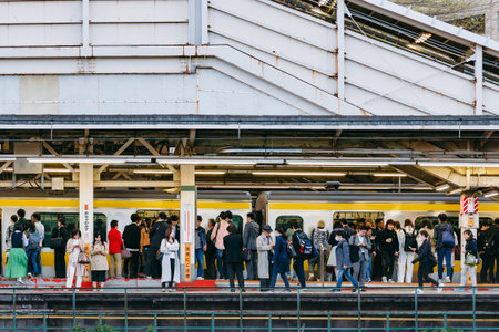 TOKYO, JAPAN - APR 16, 2019 : Japanese people waiting train on platform Tokyo city transportation JR...
