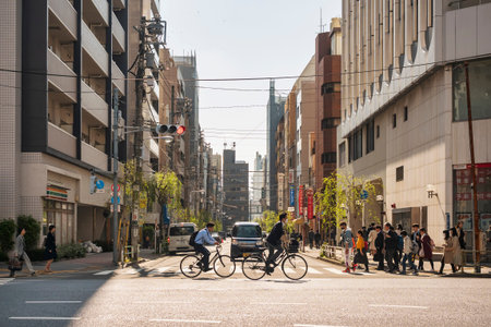 TOKYO, JAPAN - APR 18, 2019 : Japanese Businessman bike to work in morning Tokyo city street. Japan Lifestyleのeditorial素材