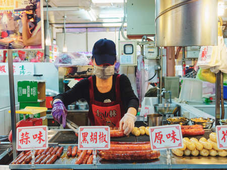 TAIPEI, TAIWAN - MAR 21, 2015 : Taiwan street food with People wear mask cooking Chinese sausage Asian Travelのeditorial素材
