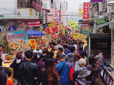 TAIPEI, TAIWAN - MAR 22, 2015 : Crowd Asian people on Tamsui Old Street with Food stall Taiwan famous shopping streetのeditorial素材