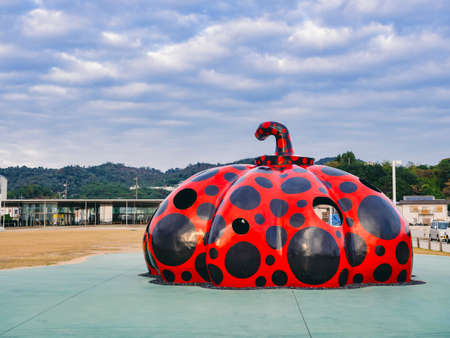 Yayoi Kusamaâs iconic pumpkin sculptures stands by Miyanoura Port Naoshima island town Japanâs Seto Inland Sea NAOSHIMA, JAPAN - NOV 25, 2019のeditorial素材