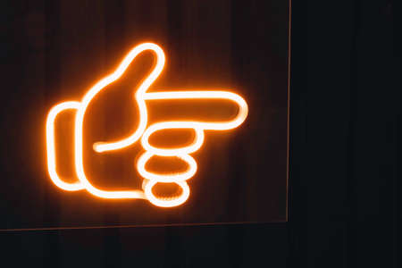 Neon sign Direction Hand point Shop signage decorationの写真素材