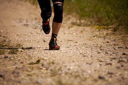 Runner athlete feet running on offroad surface.のeditorial素材