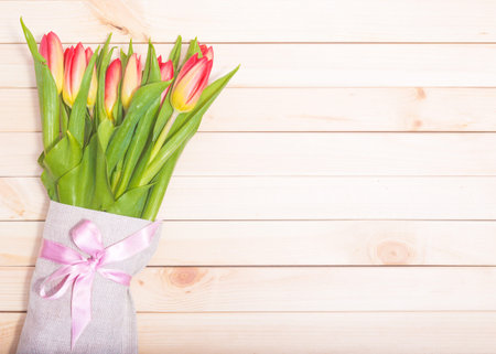 Fresh tulips on a background of light wooden boardsの写真素材