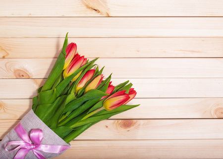 Fresh tulips on a background of light wooden boardsの写真素材