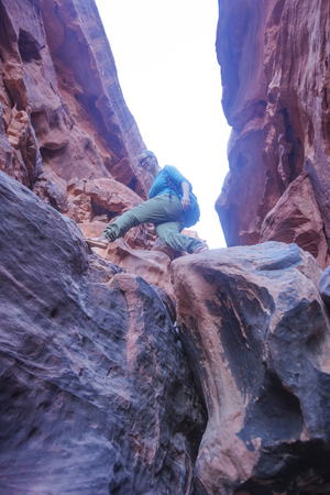 girl-traveler makes a step in a narrow gorgeの写真素材