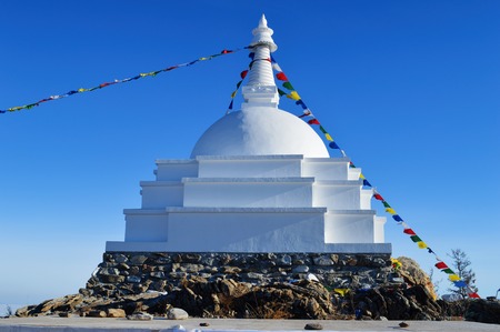 The Buddhist Stupa of Enlightenment in winter in sunny day at Ogoy Island, Baikal Lake , Russiaの写真素材
