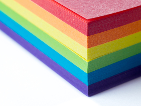 Block of sticky notes in LGBT colors isolated on a white background. Macro, shallow depth of field.の写真素材
