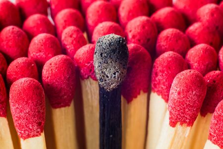 Burnout, stress, exhaustion and work-life balance concept. Single burnt match macro.の写真素材