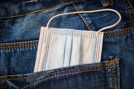 Surgical mask in back pocket. Hygiene concept.