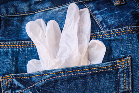White surgical gloves in back pocket. Hygiene concept.