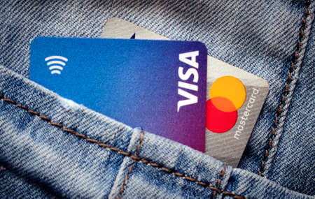 Zlin, Czech Republic - June 3, 2020: Visa and Mastercard debit cards in a pocket. Illustrative editorial.のeditorial素材