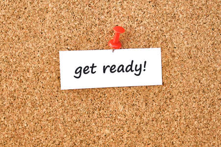 Get ready. Text written on a piece of paper or note, cork board background.の写真素材