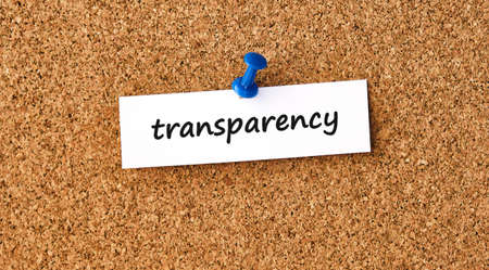 Transparency. Word written on a piece of paper, cork board background.の写真素材