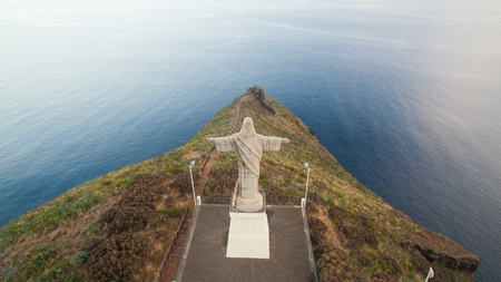 The Christ the King statue is a Catholic monument on Madeira island, Portugalの写真素材
