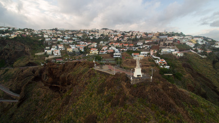 The Christ the King statue is a Catholic monument on Madeira island, Portugalの写真素材