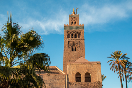 Koutoubia Mosque and palm trees in Marrakech at eveningの写真素材