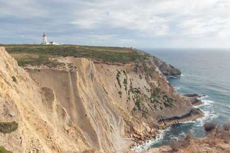 The lighthouse on a cliff near the oceanの写真素材
