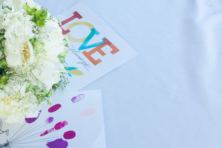 Cards and wedding bouquet on the white tableの写真素材