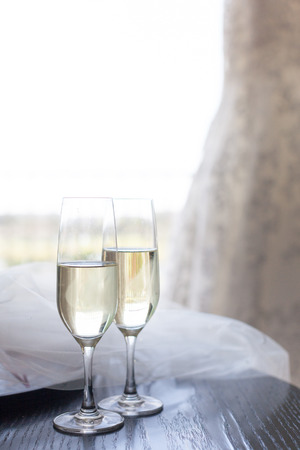 Two glasses of champagne near the wedding veilの写真素材