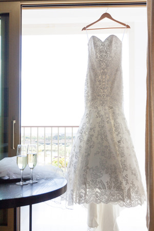 Modern white wedding dress at the windowの写真素材