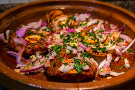 Delicious beef stew with vegetables and onion in tajine pot meatの写真素材