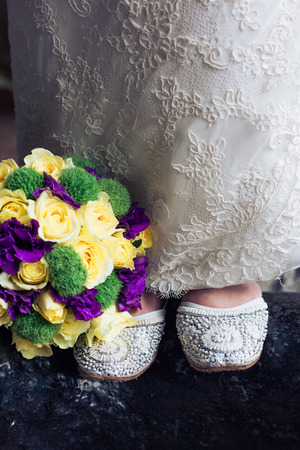 Shoes, bride, wedding dress and bridal bouquetの写真素材