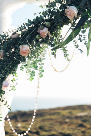 Floral wedding arch from roses on sky backgroundの写真素材