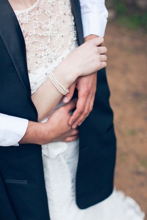 Romance: The groom embraces the bride in a white dress close-upの写真素材