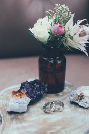 Wedding rings, crystals and roses close-upの写真素材