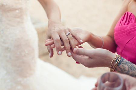 Bride shows wedding ring to girlfriend close-upの写真素材